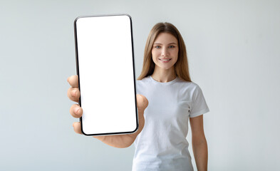 Lady holding mobile phone with empty screen in her hand