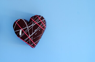 Top view of heart shaped cupcake  on blue background close up. Food, holiday concept. Copy space