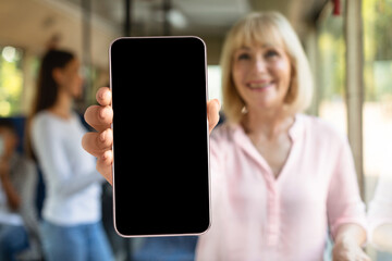 Blonde woman showing blank smartphone screen, closeup