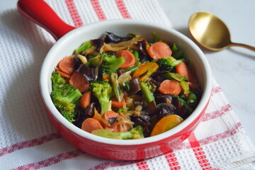 a plate of stir fry vegetables and sausages named cap cay