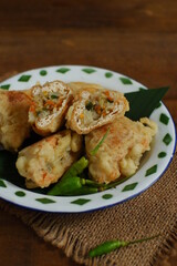 a plate of fried tofu filled with vegetables named tahu isi in Bahasa 