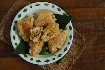 a plate of fried tofu filled with vegetables named tahu isi in Bahasa 
