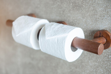 Woman hand pulling toilet paper in restroom. Cleaning, Lifestyle and personal hygiene concept