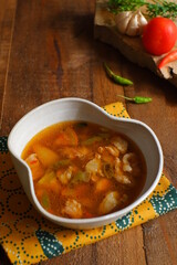 a bowl of beef cooked in spicy soup named asem asem in Bahasa 