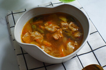 a bowl of beef cooked in spicy soup named asem asem in Bahasa 