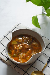 a bowl of beef cooked in spicy soup named asem asem in Bahasa 