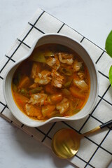 a bowl of beef cooked in spicy soup named asem asem in Bahasa 