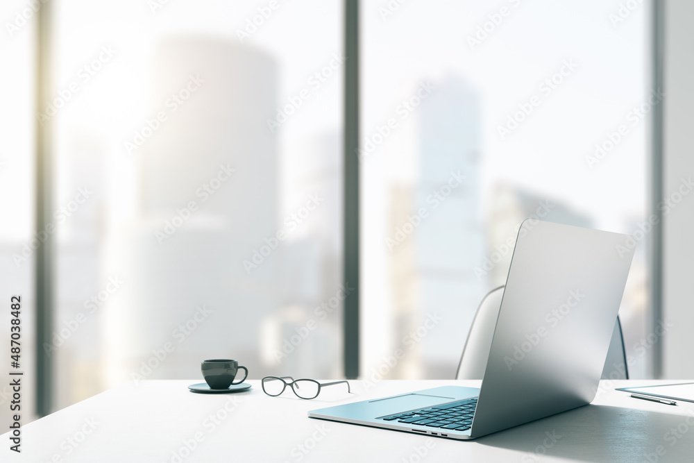 Poster close up of creative designer office desktop with mock up place on window, laptop, coffee cup and ot
