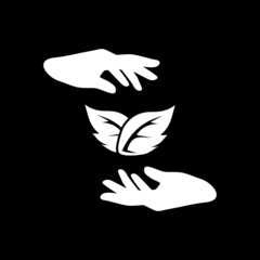 Leaf, sprout between hands icon isolated on dark background