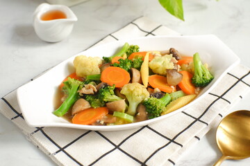 a plate of sauteed vegetables named cap cay 