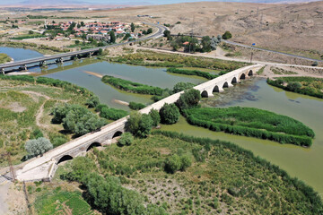 The Kesik Bridge is located on the Kizilirmak River. The bridge was built in 1248 during the Anatolian Seljuk period. A photograph of the bridge taken with a drone. Kirsehir, Turkey.