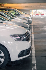 Row of cars in a car park or dealership. Selective focus. Vertical image