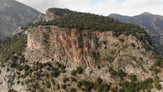 Remains of ancient Lycian rock necropol in Pinara ancient city in Turkey
