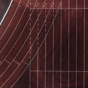 Top down view lane lines on red sports track
