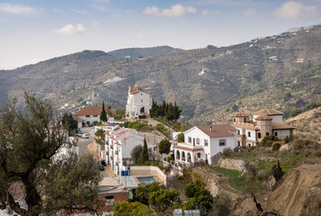 Fototapeta na wymiar small village in the backcountry of Andalusia with whitewashed houses and a chapel on the hill