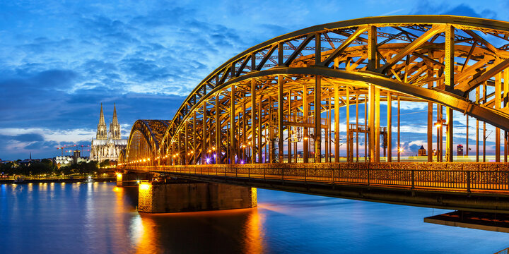 Cologne Cathedral city skyline and Hohenzollern bridge with Rhine river in Germany at twilight panorama
