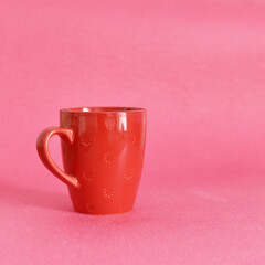 red mug on pink background