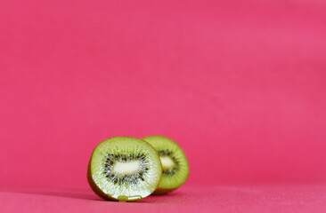 ripe kiwi in a cut on a pink background