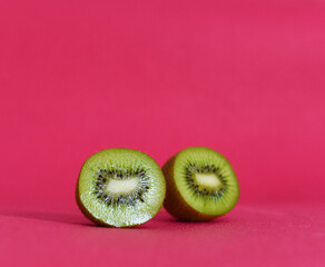 ripe kiwi in a cut on a pink background