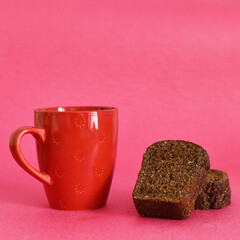 red cup and black bread on pink background