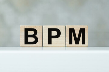 Acronym BPM - Business process management. Wooden cubes with text on an isolated table