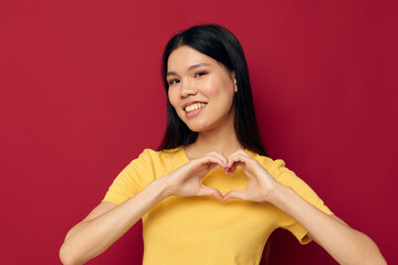 pretty brunette gestures with his hands in a yellow t-shirt casual wear Lifestyle unaltered