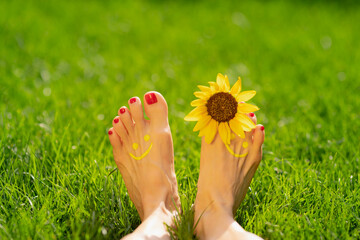 Happy woman with smile on feet outdoor in spring