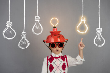 Smart child wearing funny helmet with illuminated lightbulb - 487051267
