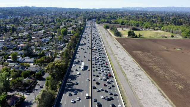 Beautiful aerial panorama of busy traffic on multi-level highway. Aerial view of busy cars with traffic jam in the rush hour on highway road street.  Traffic Jam Aerial View.
