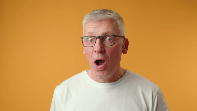 Handsome senior man wearing glasses afraid and shocked with surprise expression