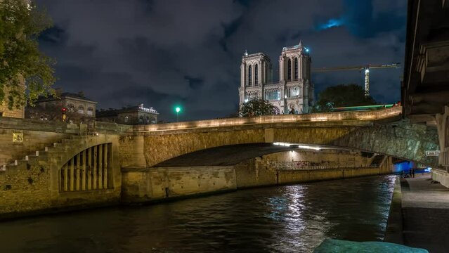 Notre-Dame Cathedral at Night Paris Seine River and Bridge Boats Cruises Tourism Clouds