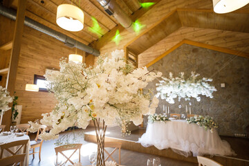 banquet table is decorated with plates, cutlery, glasses, candles and flower arrangements