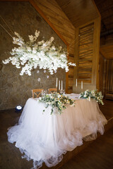 banquet table is decorated with plates, cutlery, glasses, candles and flower arrangements