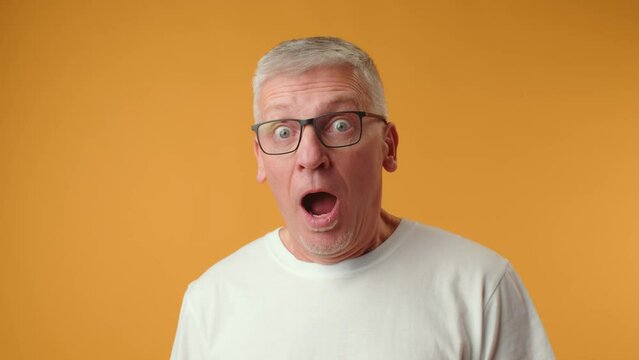 Handsome senior man wearing glasses afraid and shocked with surprise expression
