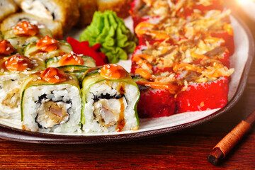 Close up top view of sushi set rolls with cucumber, shrimp tempura. selective focus