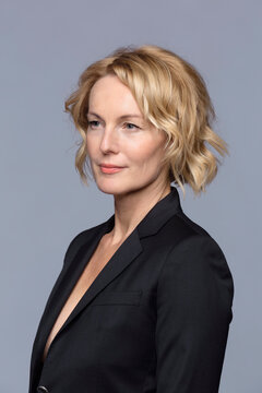 Portrait smiling, forward looking blonde businesswoman looking away
