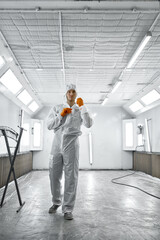 Portrait automobile painter standing in paint chamber