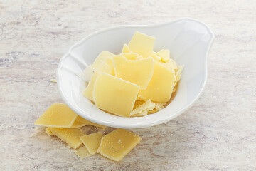 Sliced parmesan cheese heap in the bowl