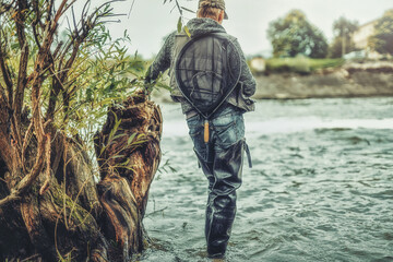 Fisherman with rod fishing on the river.