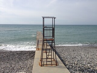 A metal lifeguard post on the concrete pier. A lifeguard post on the coastline. Rescue. Safety. Water. Measurement. Prevention. Aid. Assistance. Rescuers