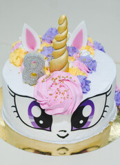 Beautiful cake in the form of a fabulous unicorn. Vertical