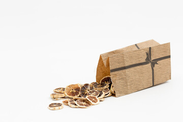 dried lemon slices, poured out of a bag on a white background