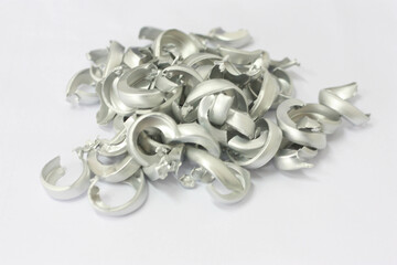 aluminum seals from beer can on a white background, recyclable material
