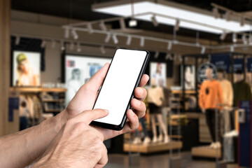 Blank smartphone screen on fashion shopping mall blurred background. Digital retail, e-commerce, shopping, app concept