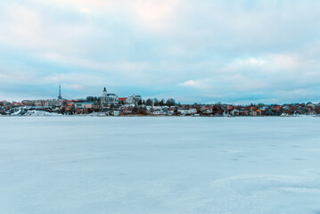 Telsiai town and lake in Lithuania Nice view winter of houses on coast of frozen Lake.Nice winter evening.