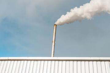 Pipe and smoke.Polluting air with white smoke from industrial chimney outdoors. CO2 emissions.Copy...