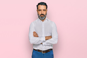 Middle aged man with beard wearing casual white shirt skeptic and nervous, disapproving expression...
