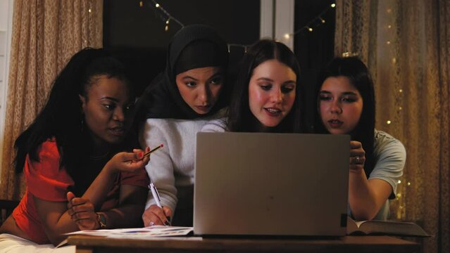 Diverse Girls students study on laptop, looking at screen, making project, having success excitement, giving five to each other. Completed task and project, final test, luck.