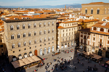 Top view on crowded Signoria square near Vecchio palace on a sunny day in Florence, Italy. Cityscape of most significant city of Tuscany