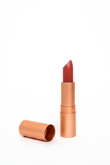 Nude lipstick in a copper case on a white background